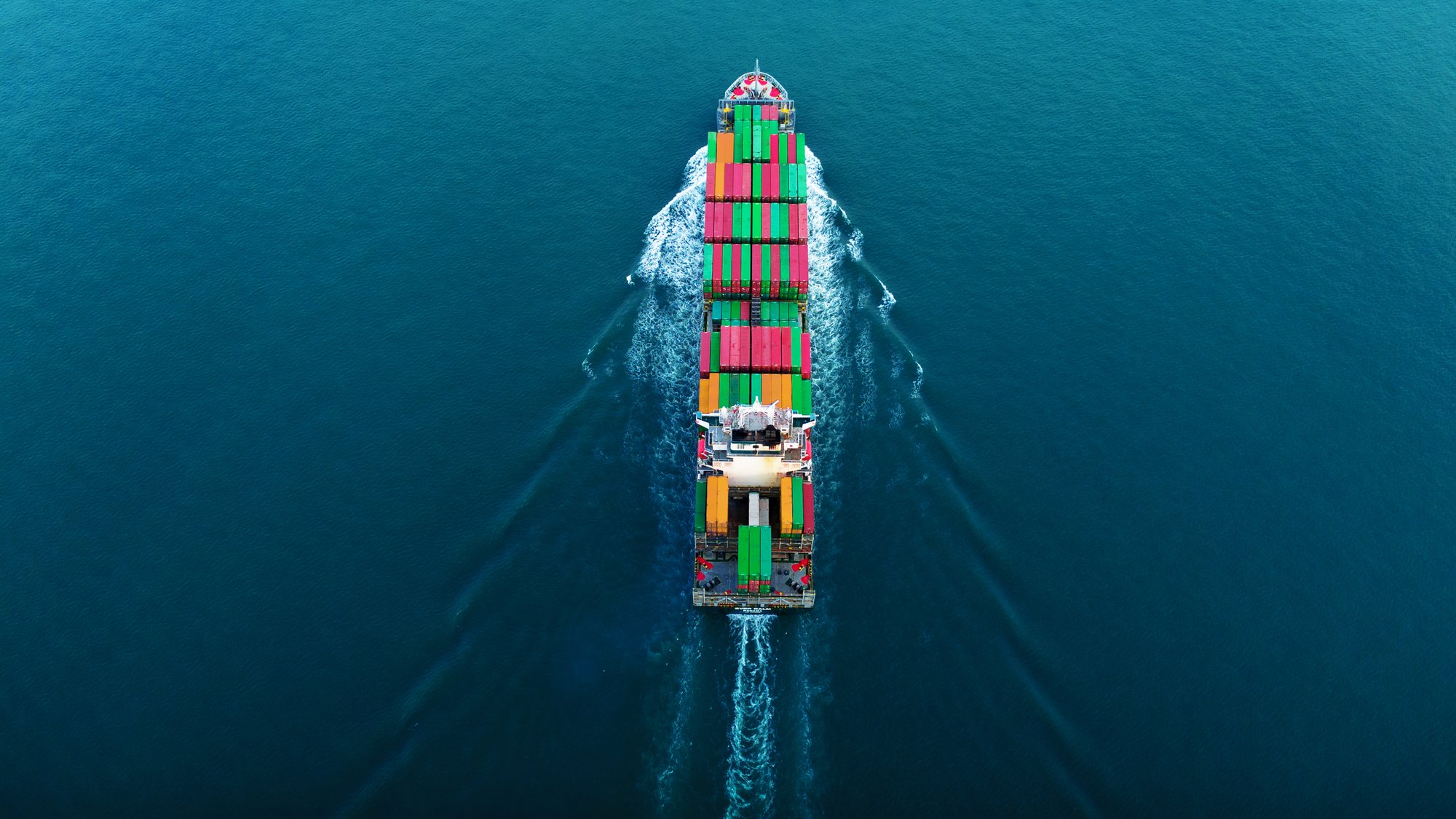 top-view-cargo-container-ship-with-contrail-in-the-2024-12-08-00-51-19-utc